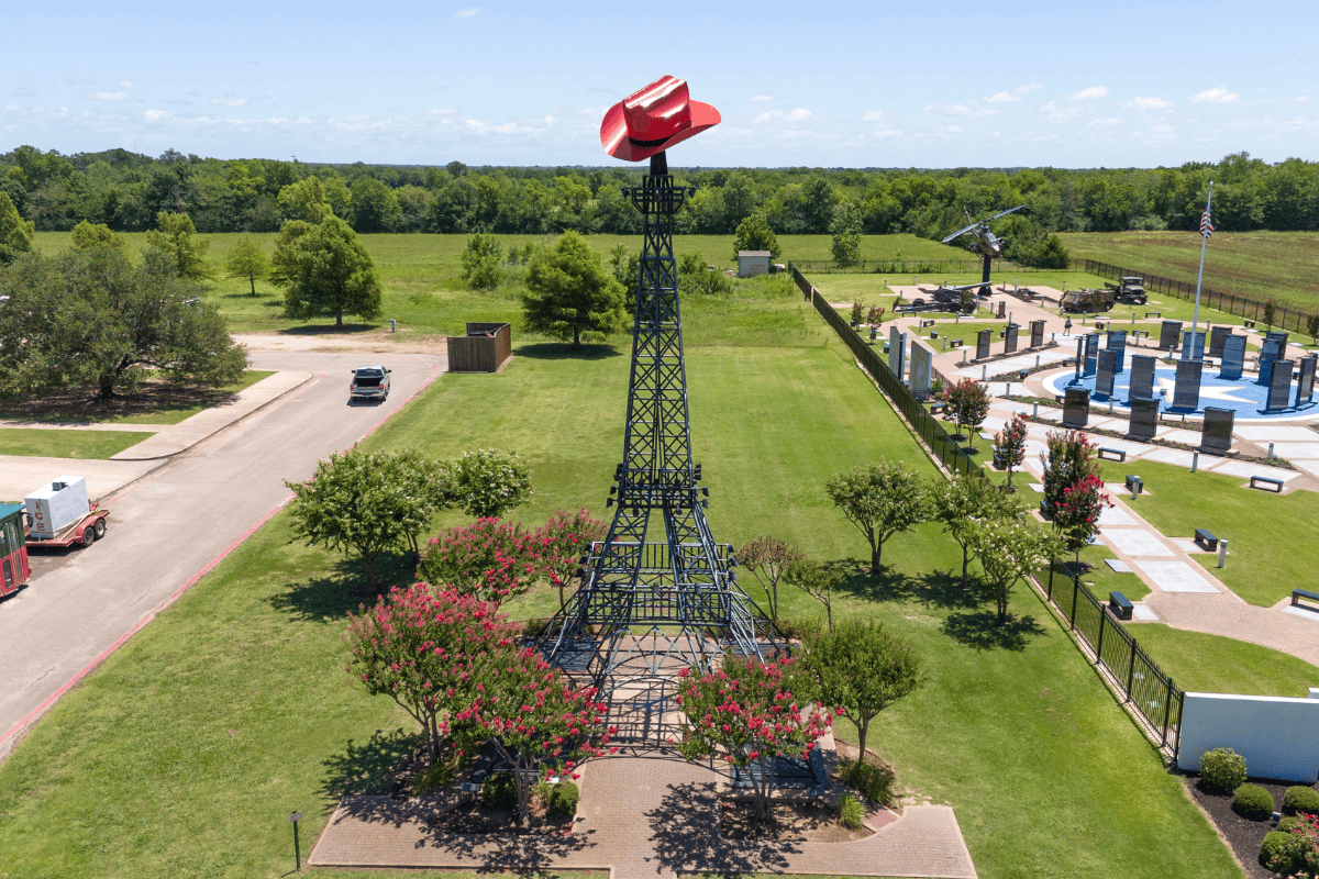 Aerial view of a large red hat sculpture on top of a tower