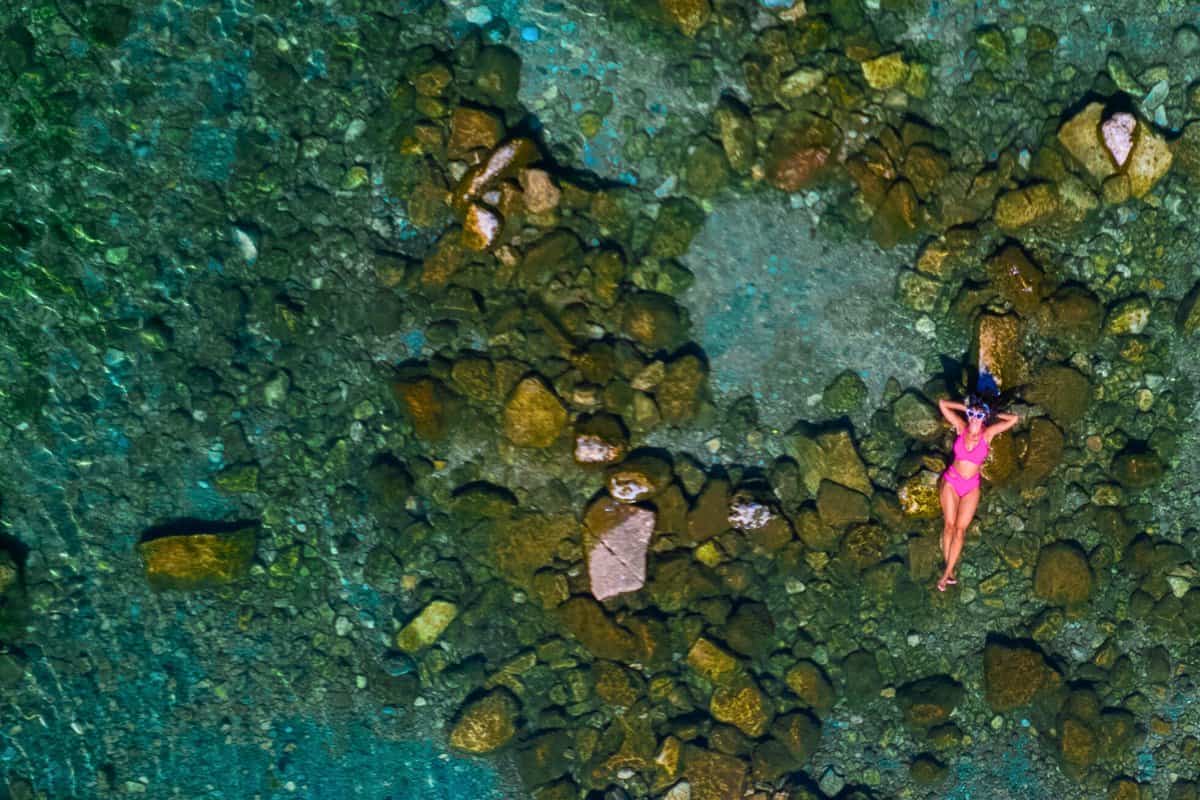 Aerial view of a person in a pink swimsuit