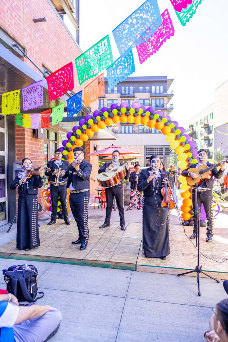 Mariachi band performing under colorful papel picado