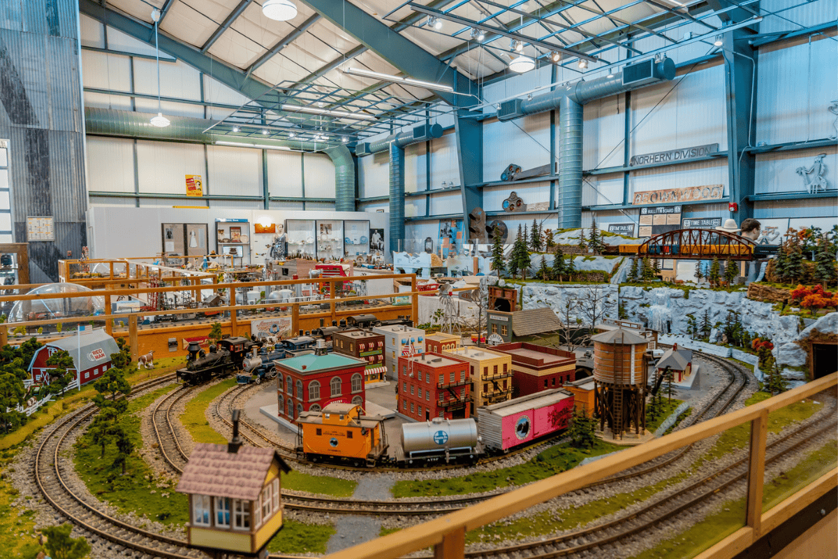  A detailed model train set inside a room with a large window