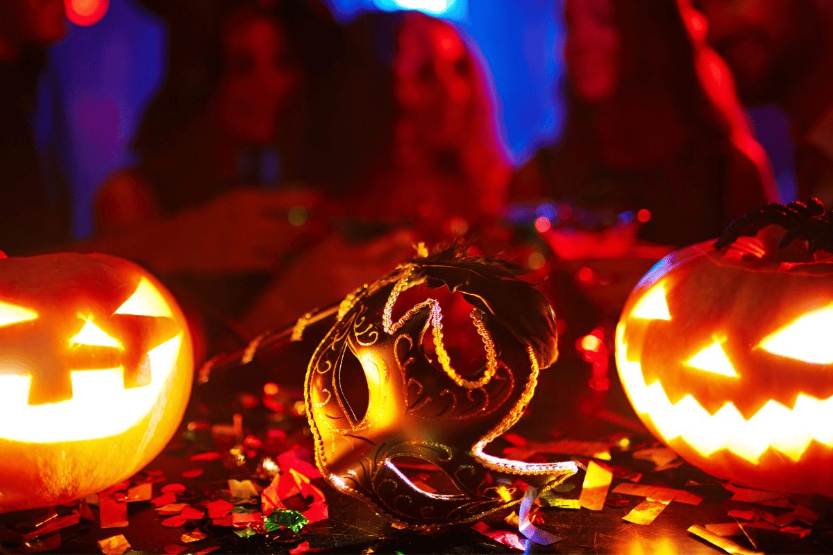  Colorful Halloween pumpkins and a mysterious mask displayed on a table