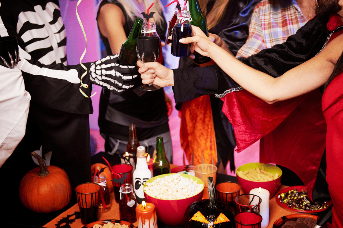 People in costumes toasting at a Halloween party