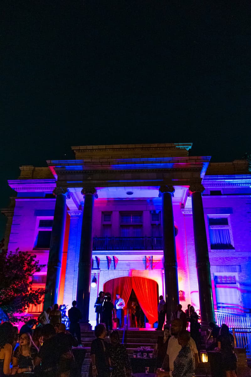 A haunted mansion surrounded by a crowd of people