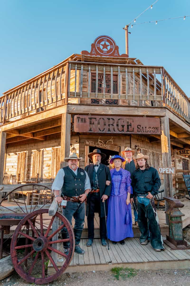 Group in period costumes outside 'The Forge Saloon'