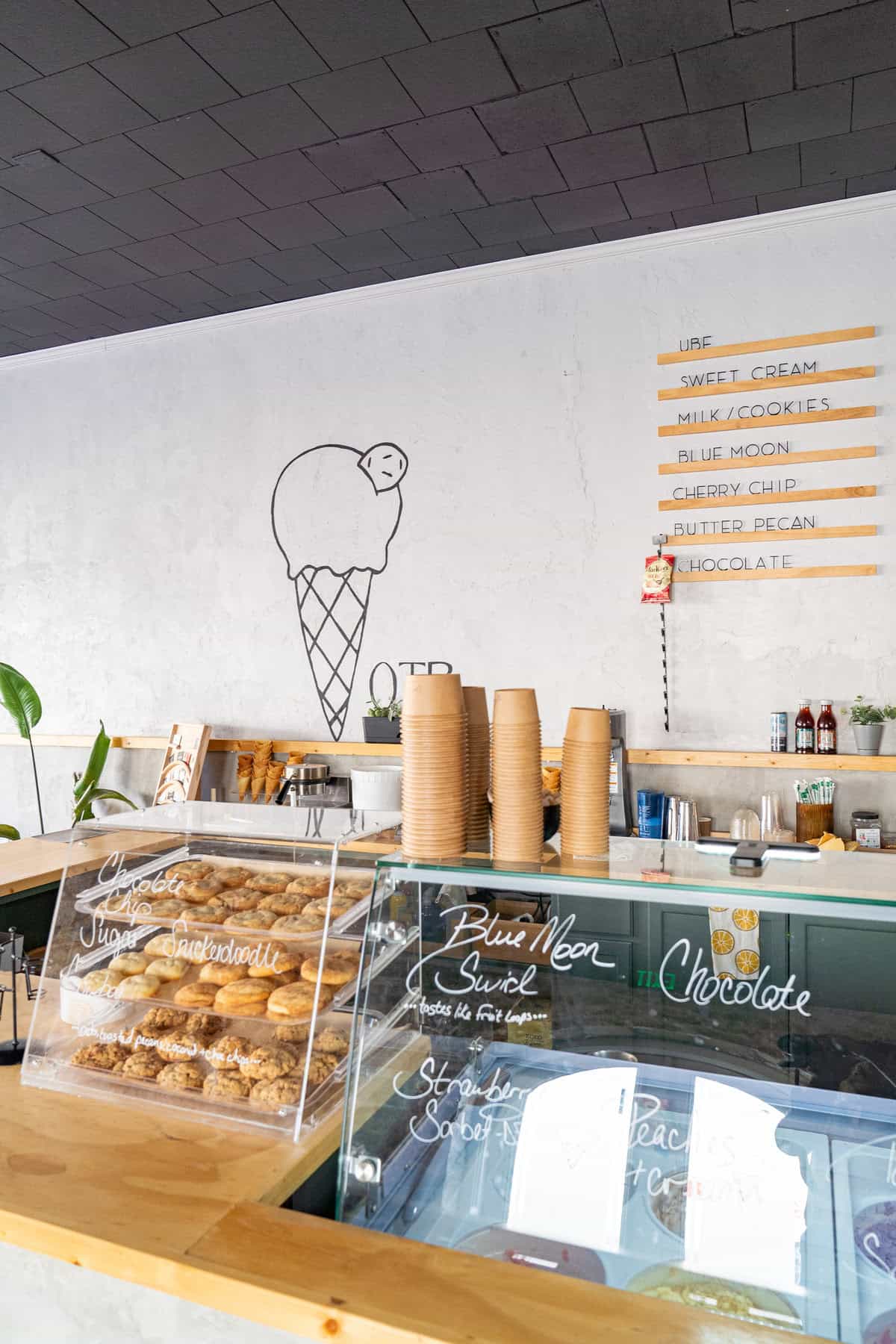 A colorful shop interior featuring a counter and a giant ice cream cone 