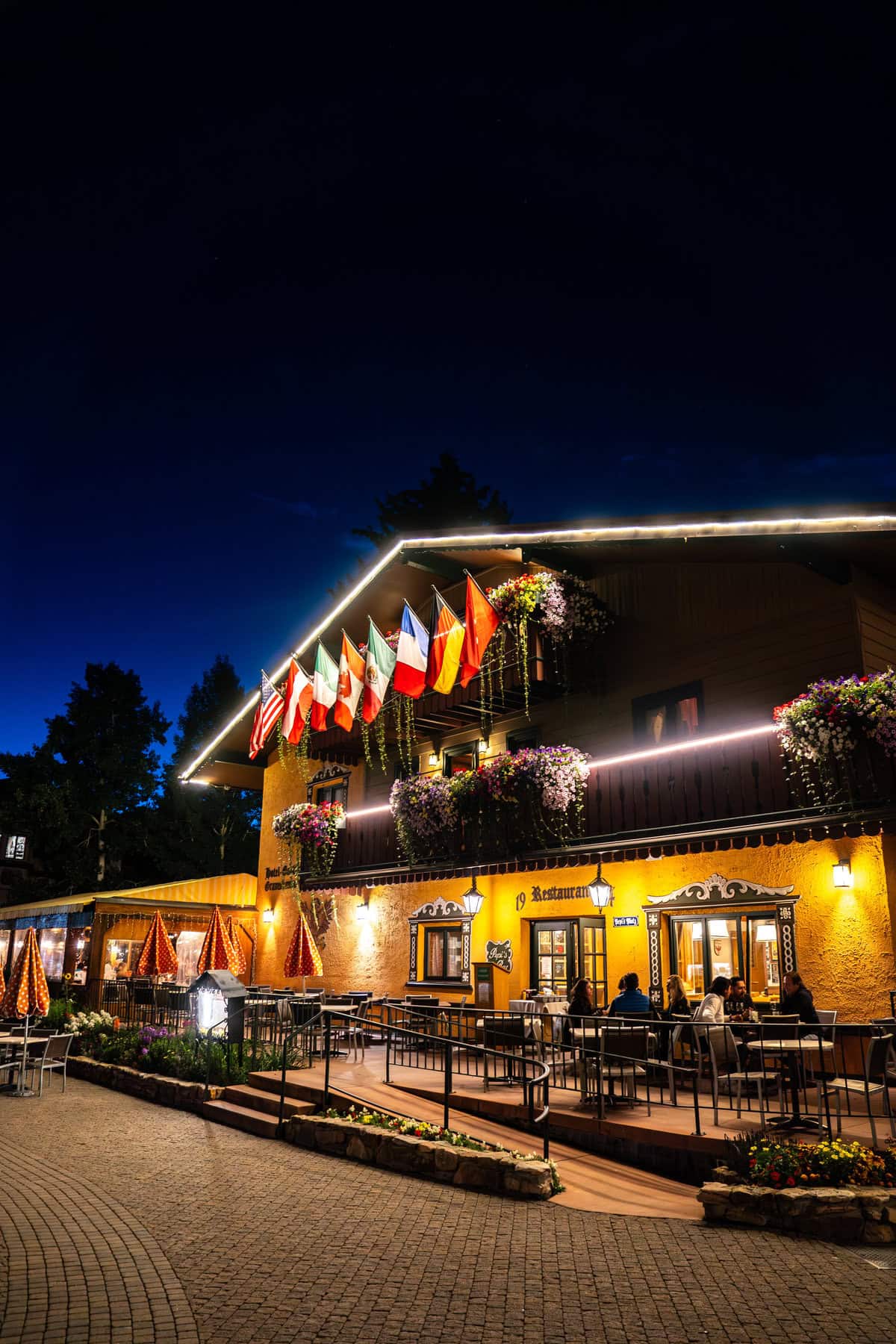 A warmly lit restaurant exterior at night