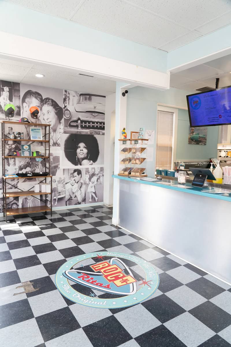 Interior of a retro-themed shop with checkered flooring and vintage decor.