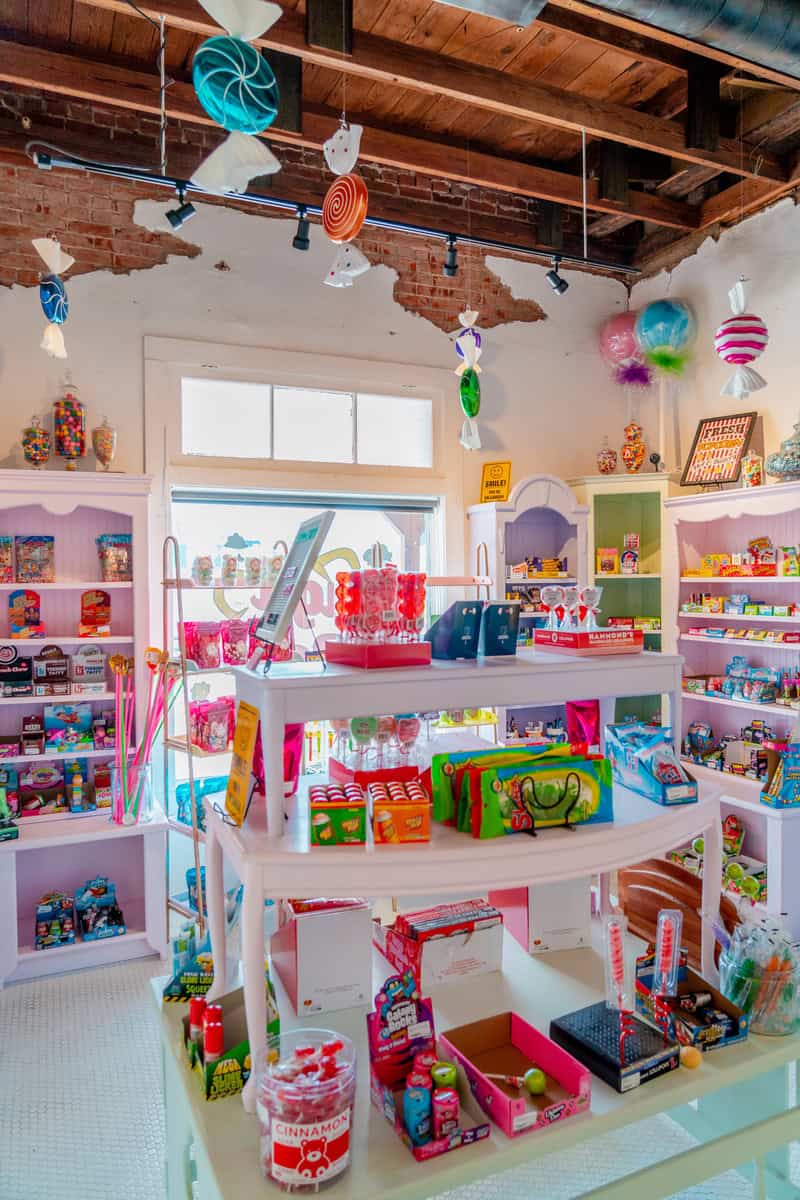 A room with shelves overflowing with candies and toys,