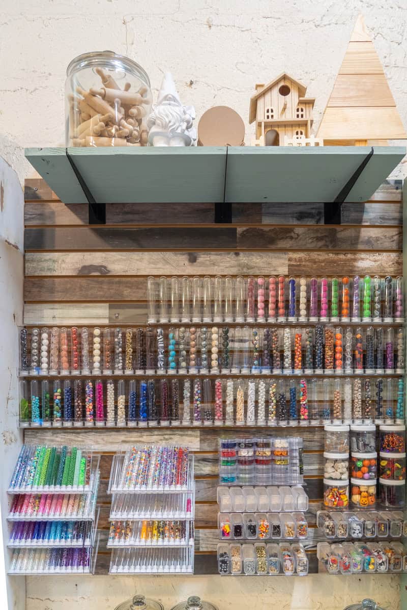 A craft shelf displaying a colorful assortment of beads