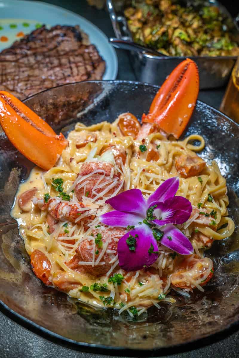 Creamy pasta with lobster, tomatoes, and parsley