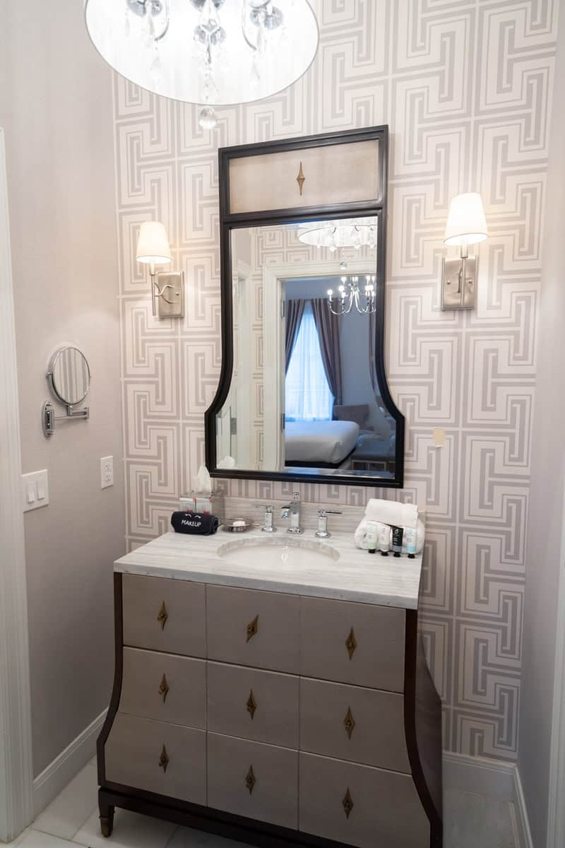 An elegant bathroom vanity with a large mirror,