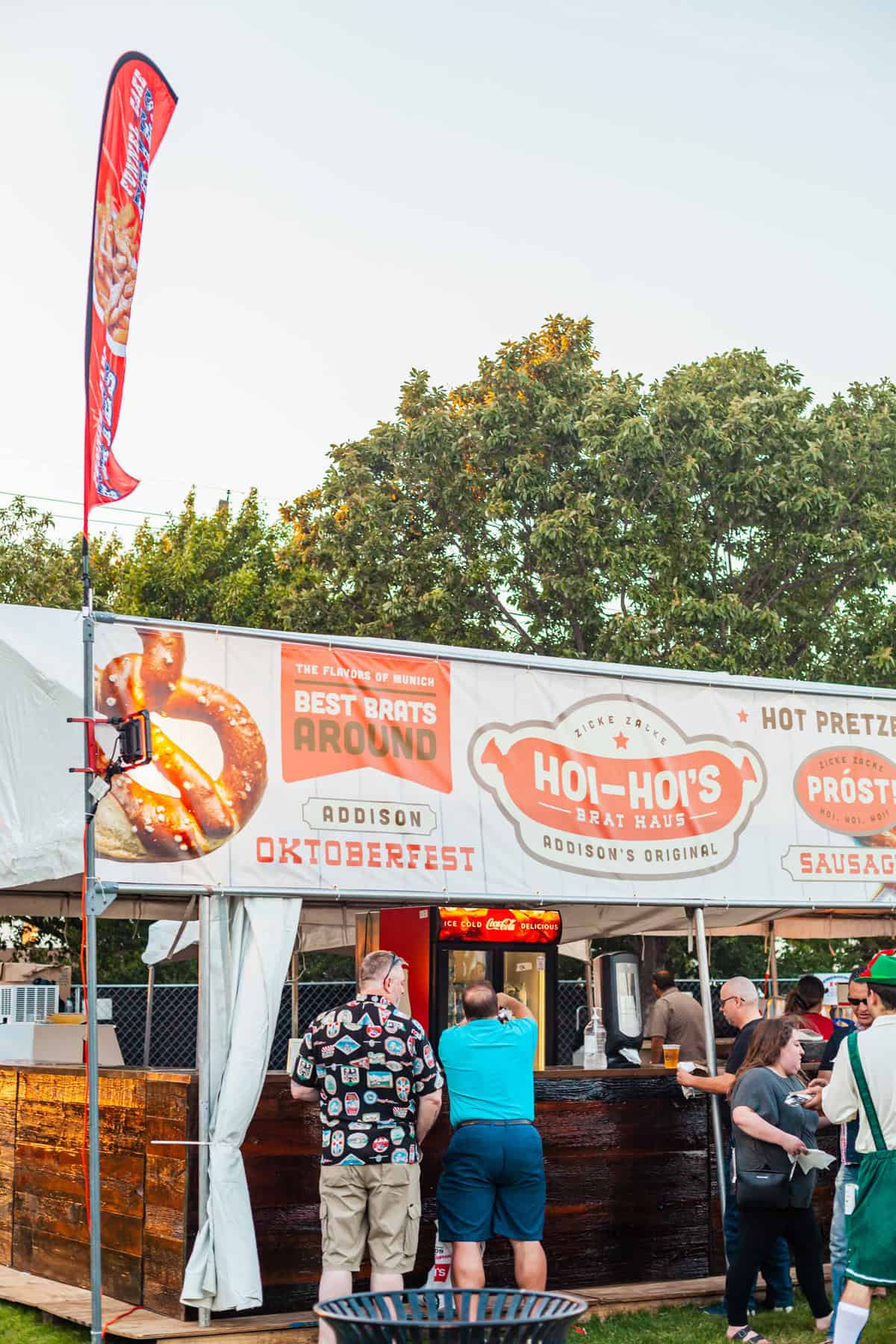 Food stall at Oktoberfest offering brats and pretzels