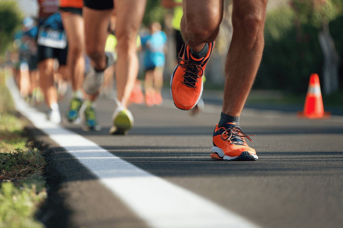 Runners' legs and feet on a road during a marathon