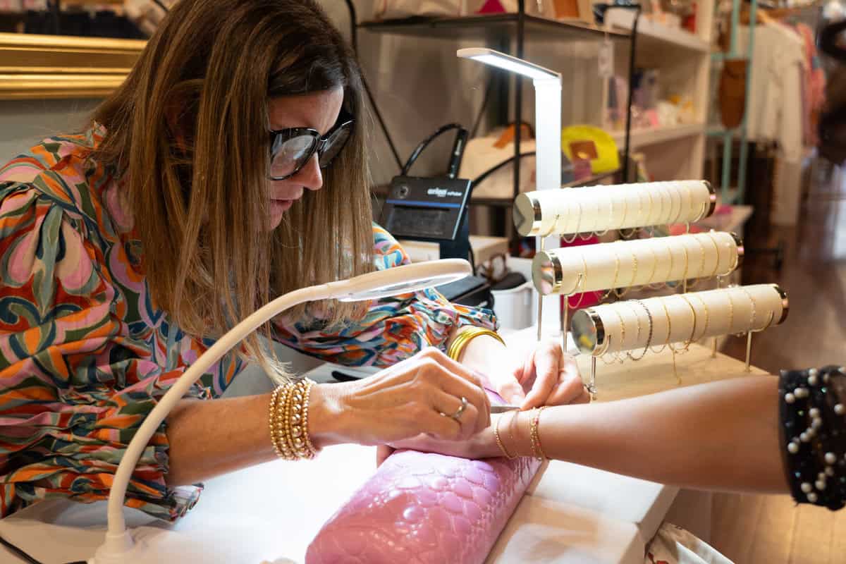 A person getting a manicure at a nail salon table 