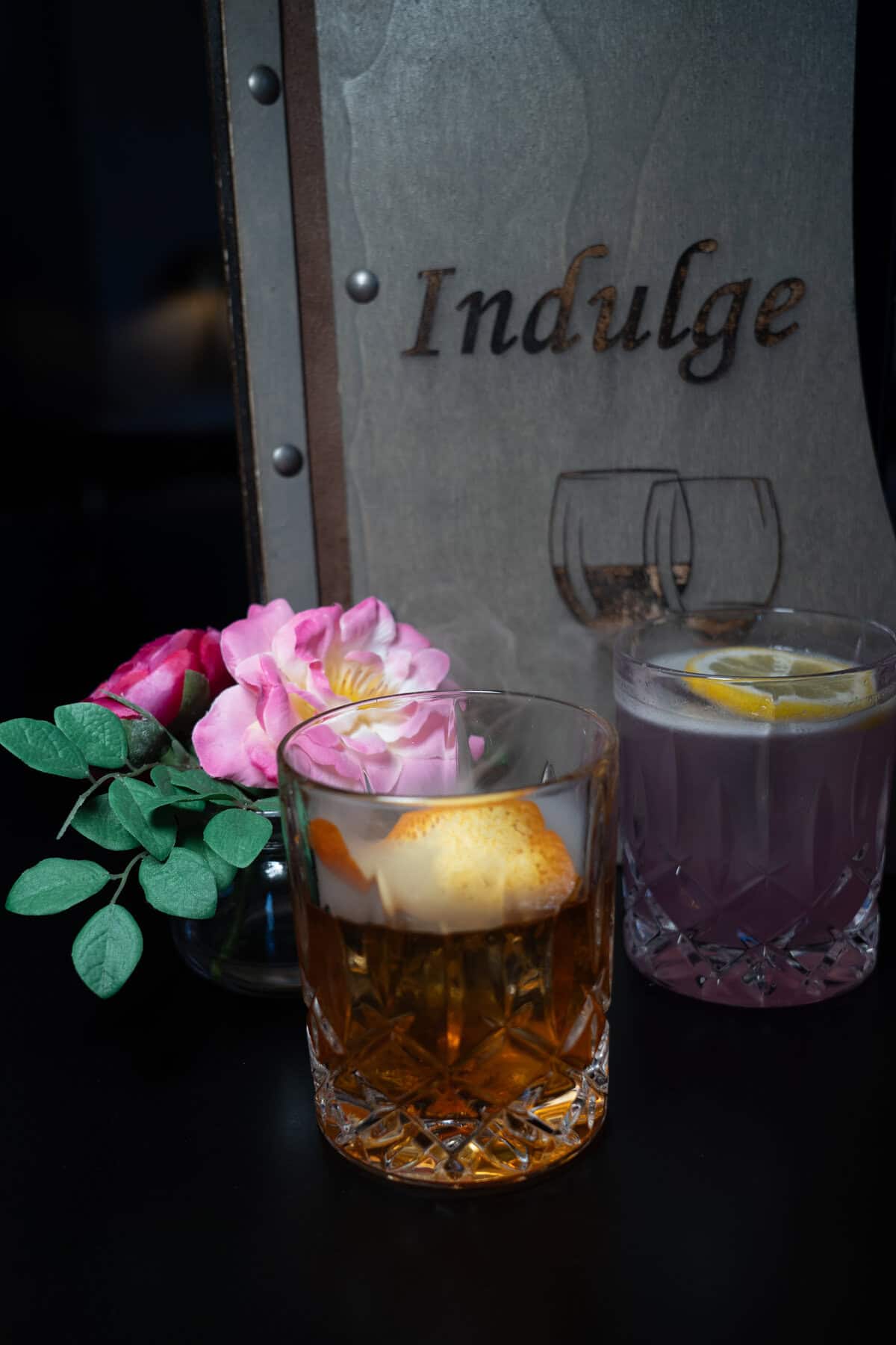 Two cocktails near a floral arrangement