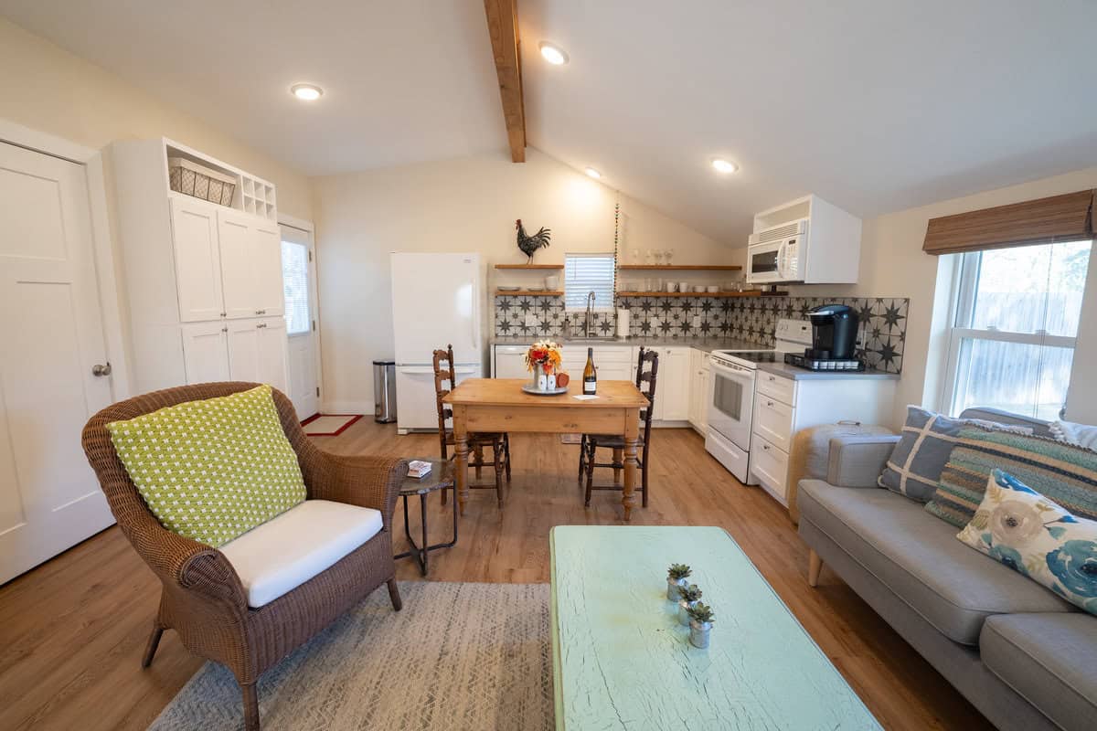 Cozy interior of a small home with kitchen, dining table, and living area.