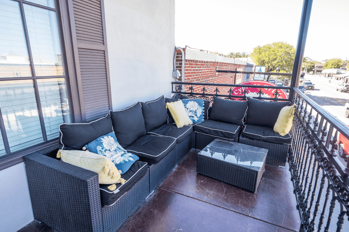 A cozy balcony featuring stylish black wicker furniture 