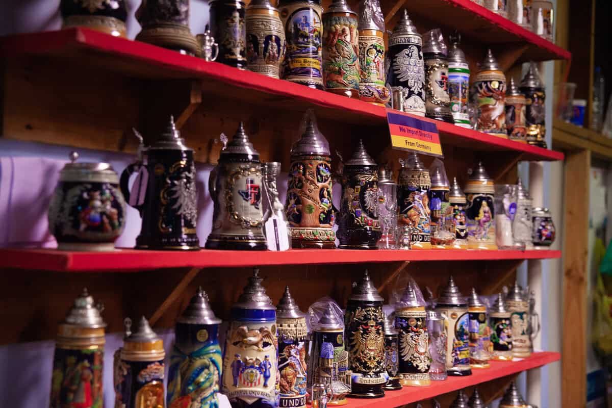 Shelves of various decorative beer steins with intricate designs.