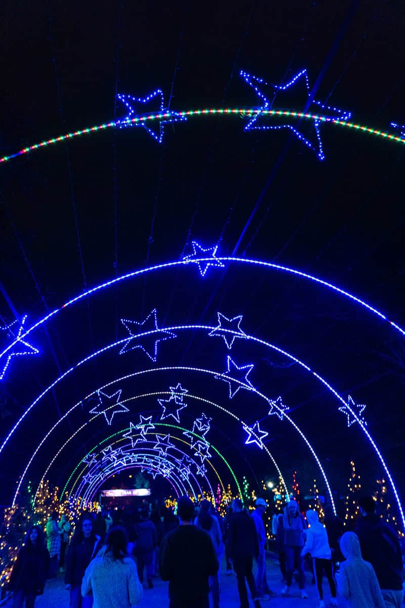 People stroll through a brightly lit tunnel