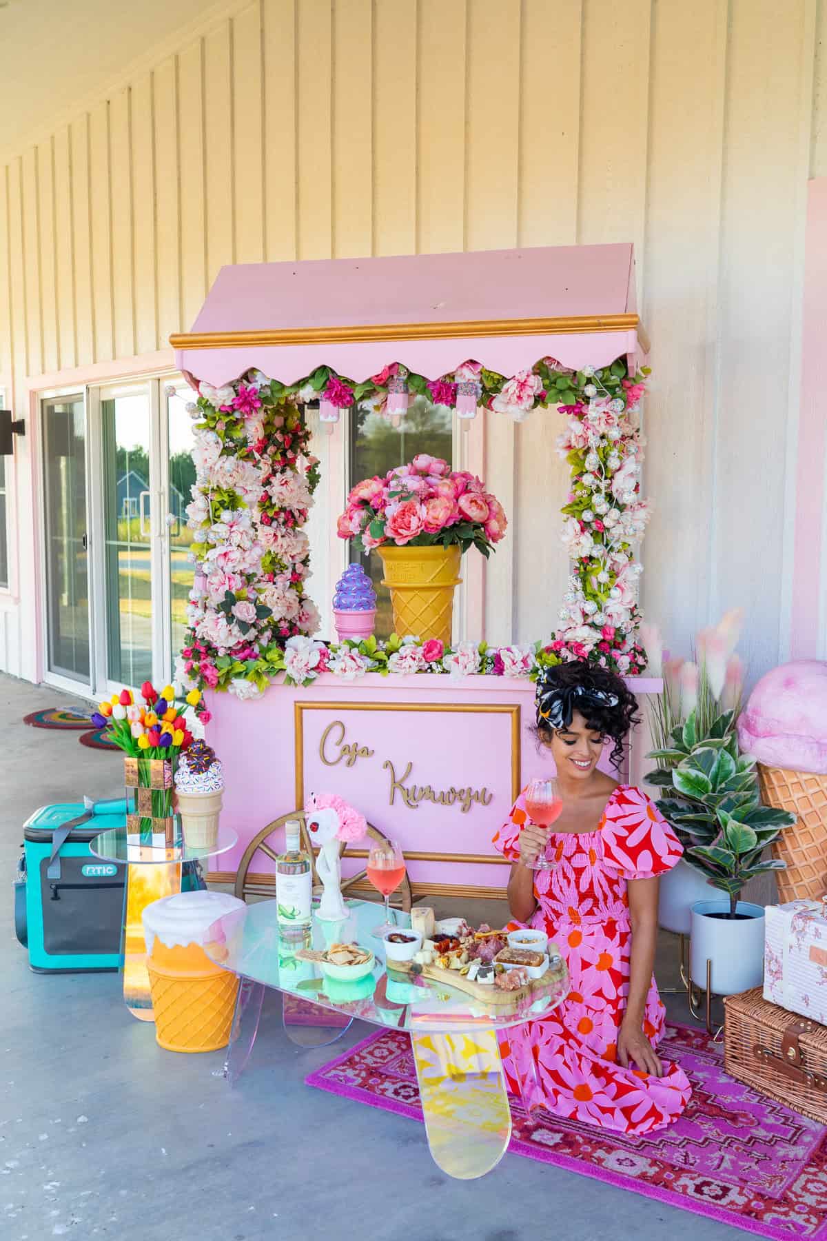 Colorful picnic setup with ice cream and floral decorations, pink theme.