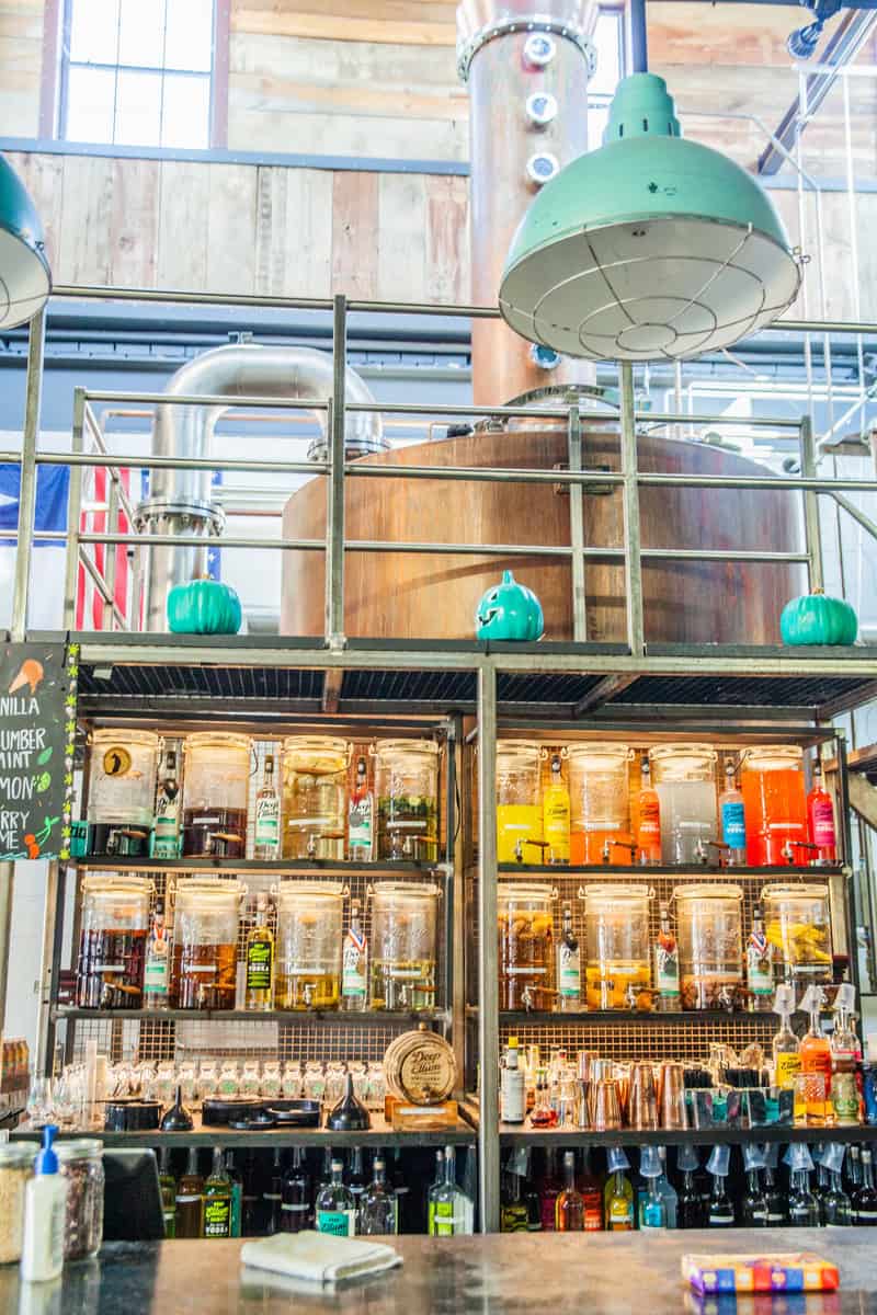 A spacious distillery bar featuring a large copper still