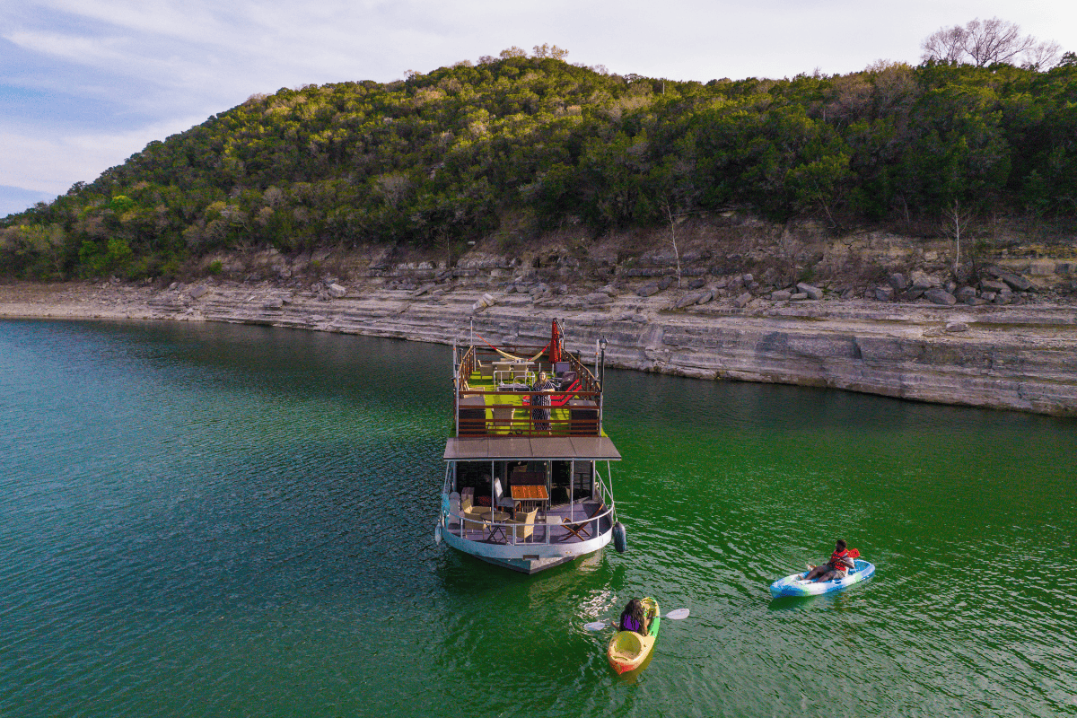 A houseboat anchored in a green lake