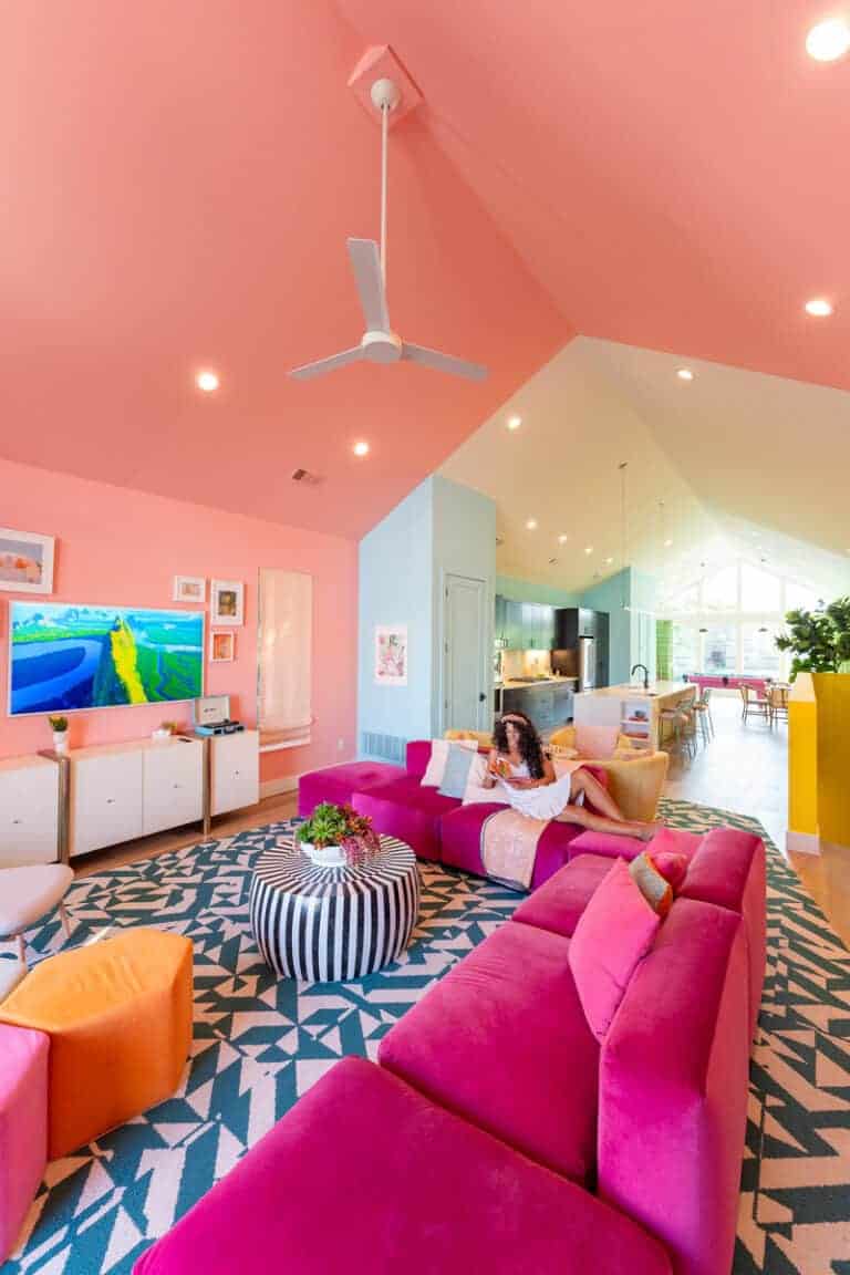 Brightly colored living room with pink walls and ceiling