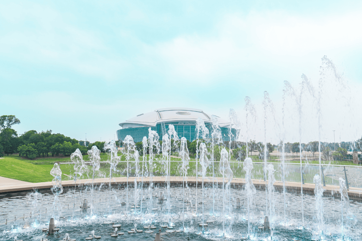 A fountain sprays water in the foreground