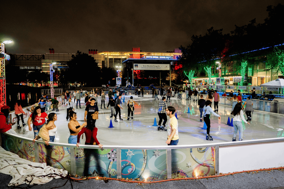 A lively ice skating rink filled with skaters of all ages