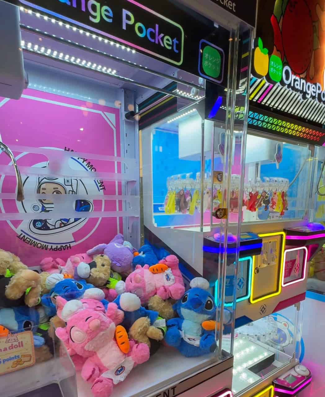 Orange Pocket claw machines with colorful plush toys in Shenandoah, Texas