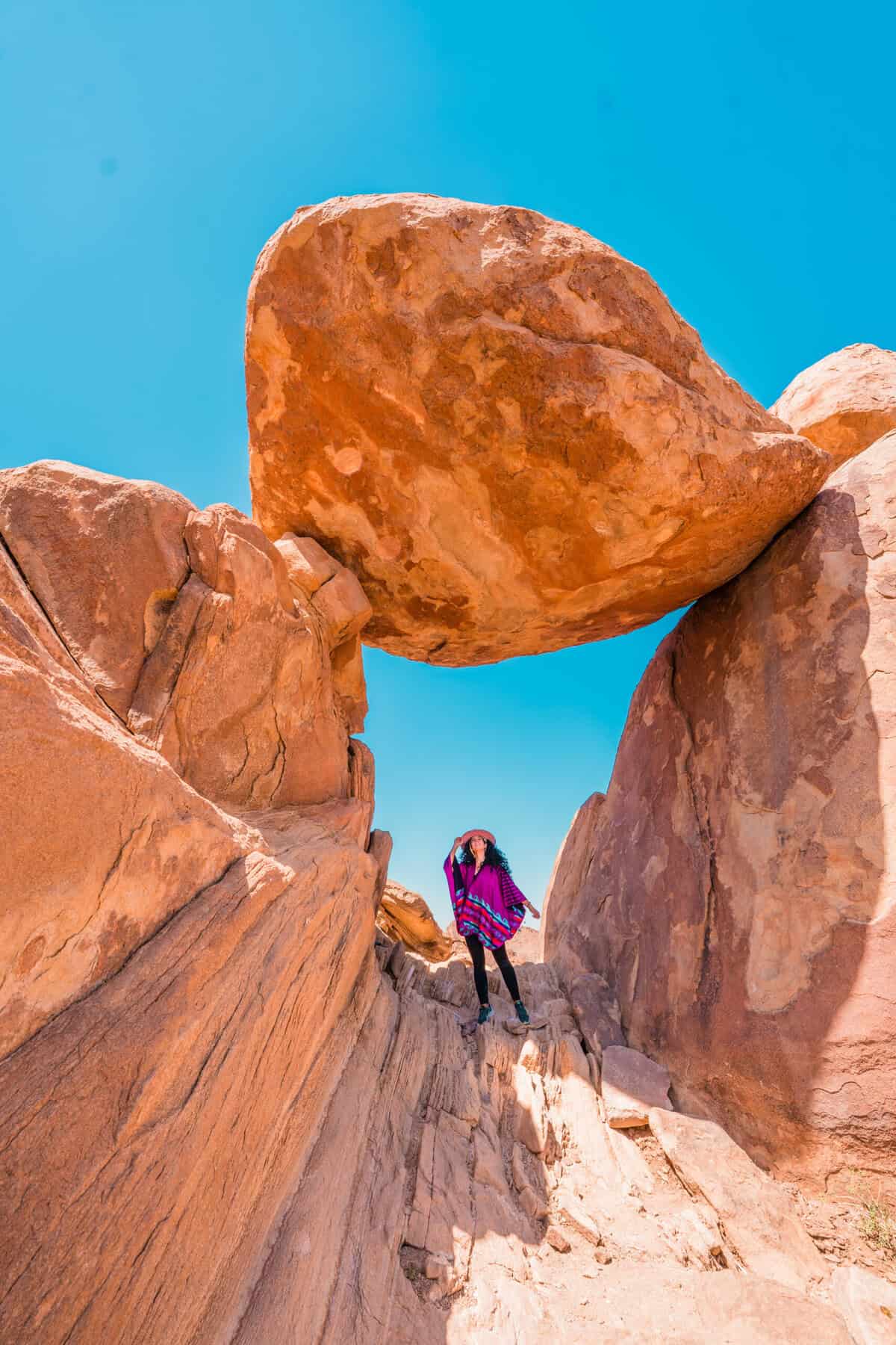 Rocky Big Bend landscape with Jessica sitting beneath balancing rock