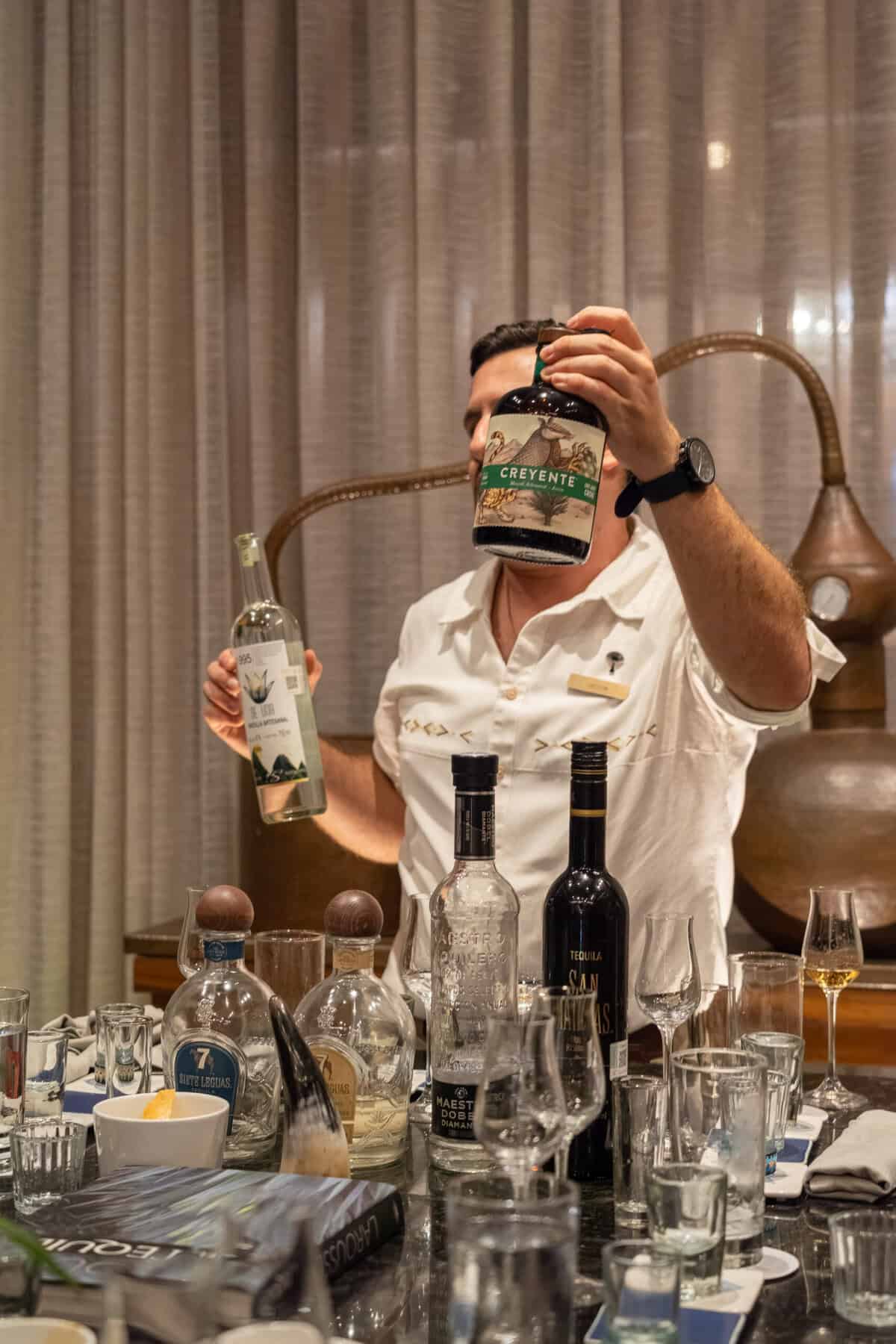 Agave tasting host presenting bottles during a tasting at Conrad Punta de Mita.