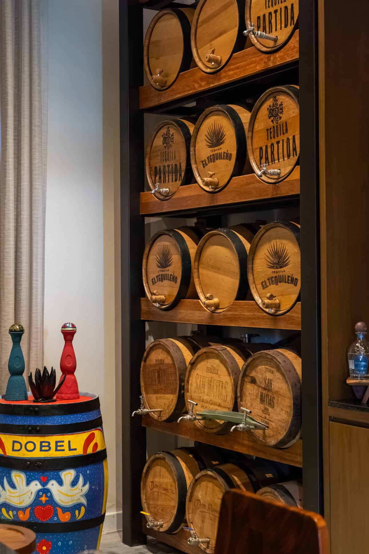 Shelves of tequila barrels in the agave tasting room at Conrad Punta de Mita.