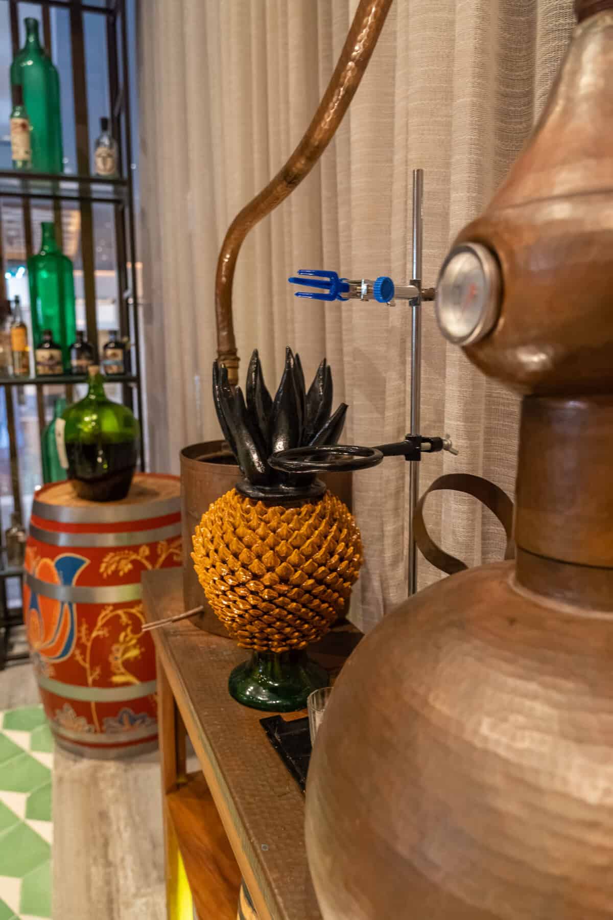 Copper still and agave decor during the agave tasting experience at Conrad Punta de Mita.