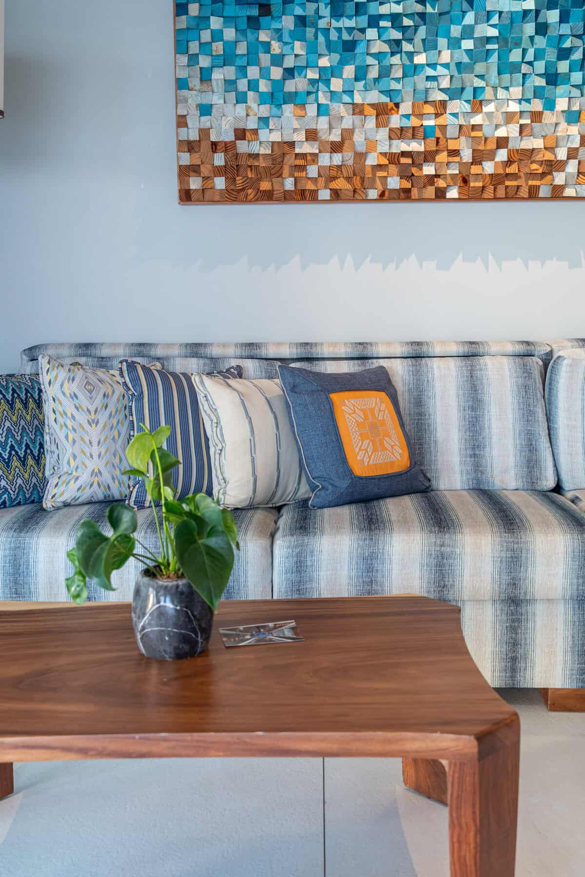 Close-up of sofa and wall art in an ocean view suite at Conrad Punta de Mita.