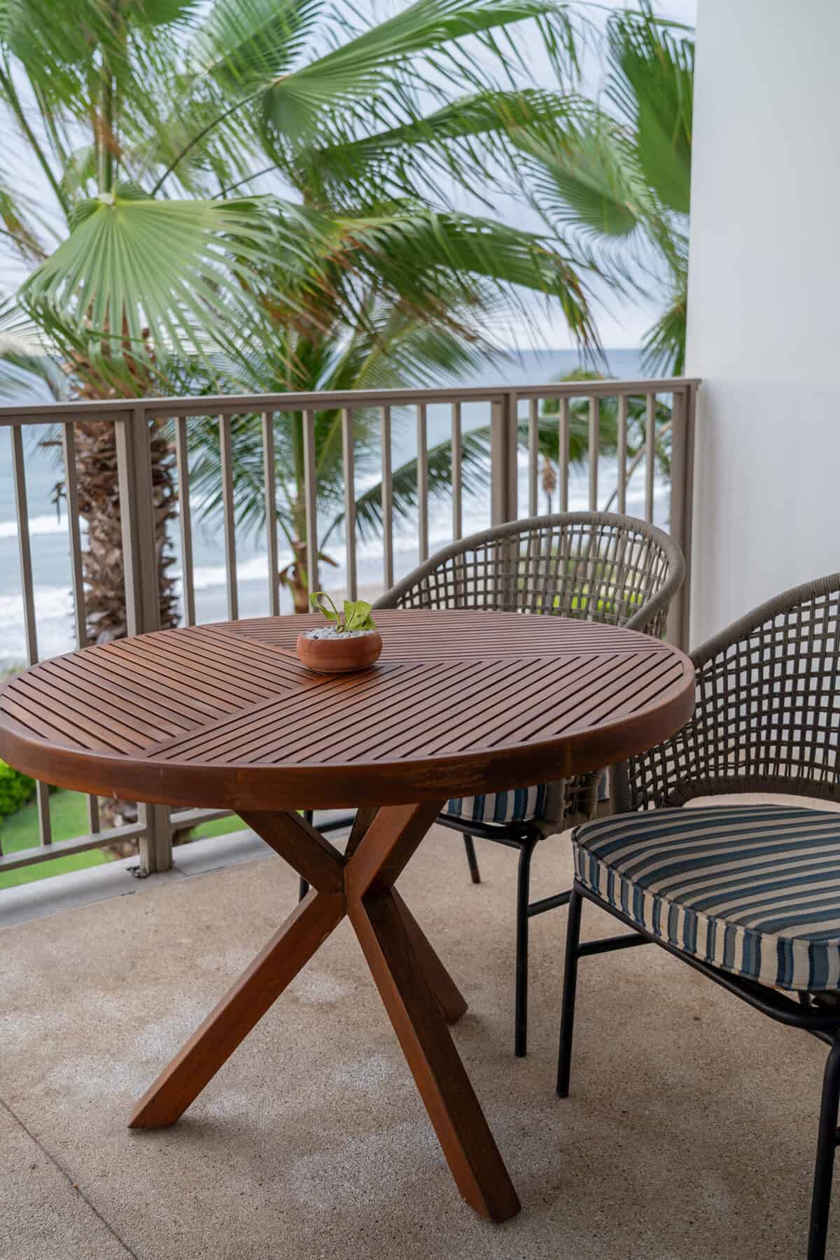Patio table and chairs with an ocean view outside a suite at Conrad Punta de Mita.