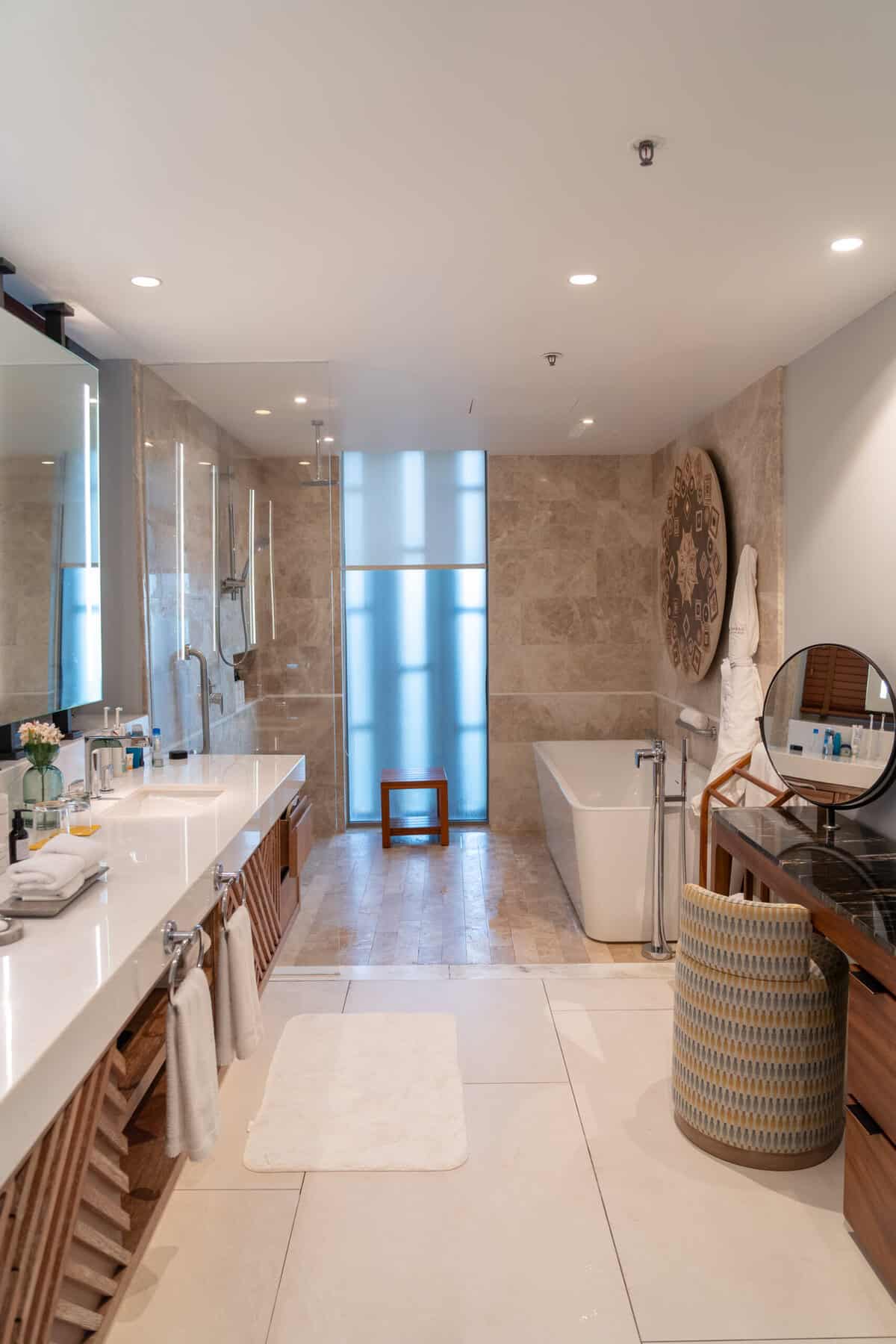 Full suite bathroom with double vanity, shower, and soaking tub at Conrad Punta de Mita.