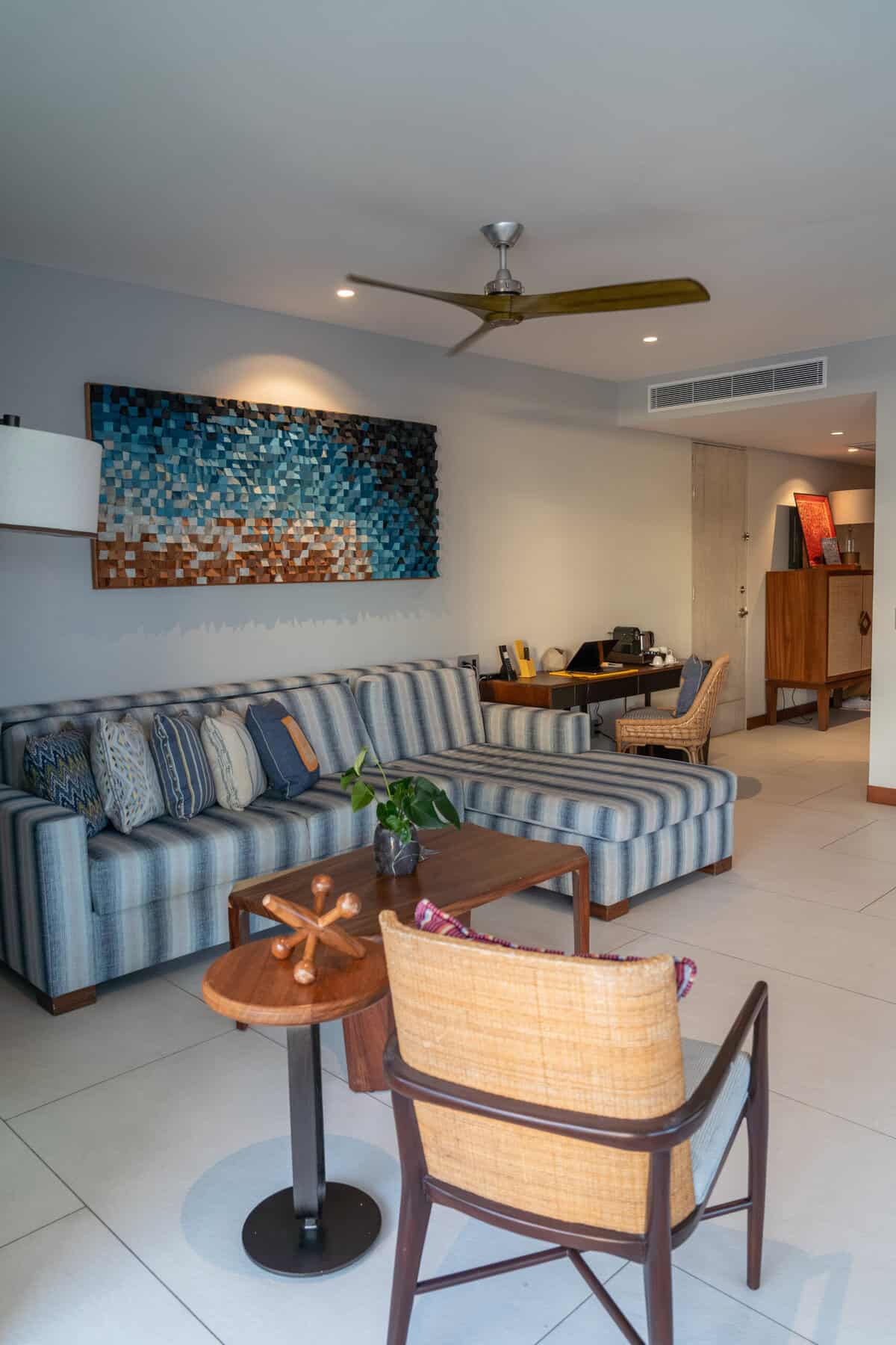 Living room seating and desk in an ocean view suite at Conrad Punta de Mita.