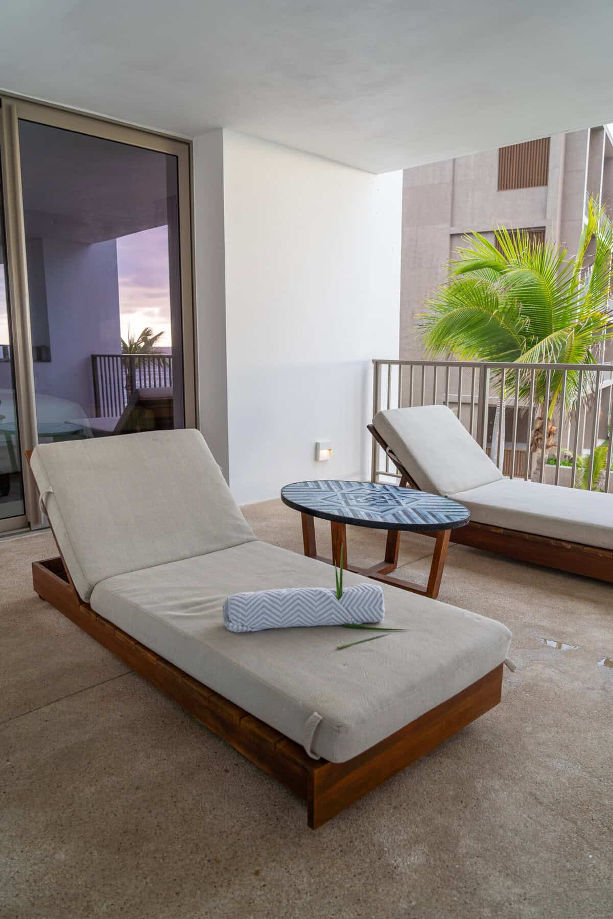 Patio chaise lounges outside a suite at Conrad Punta de Mita.