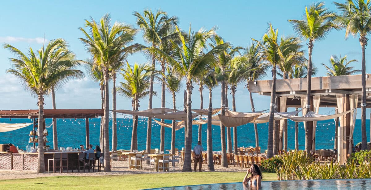 Infinity pool with ocean view and palms at Conrad Punta de Mita.