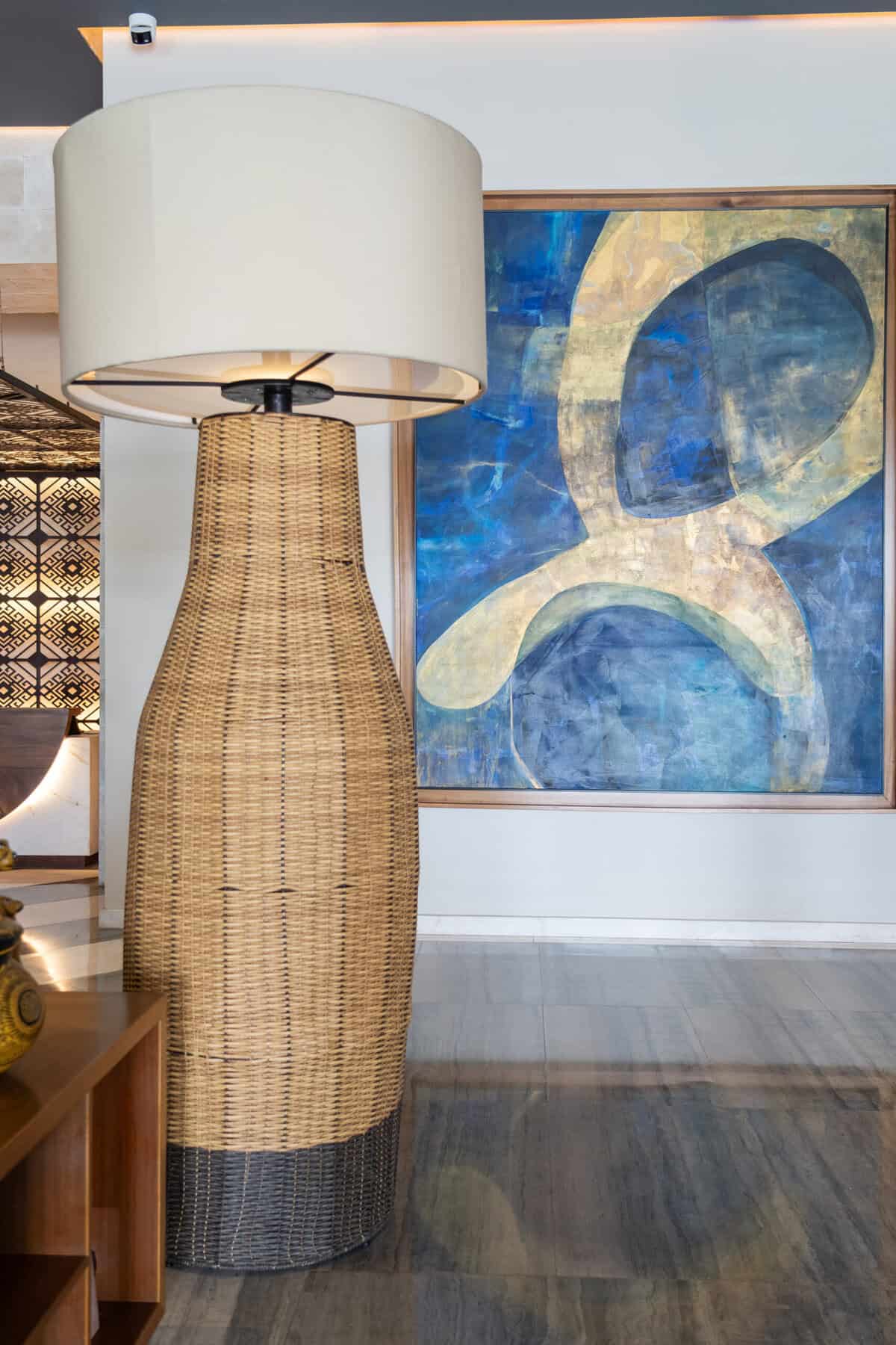 Woven floor lamp and blue abstract artwork in the lobby at Conrad Punta de Mita.