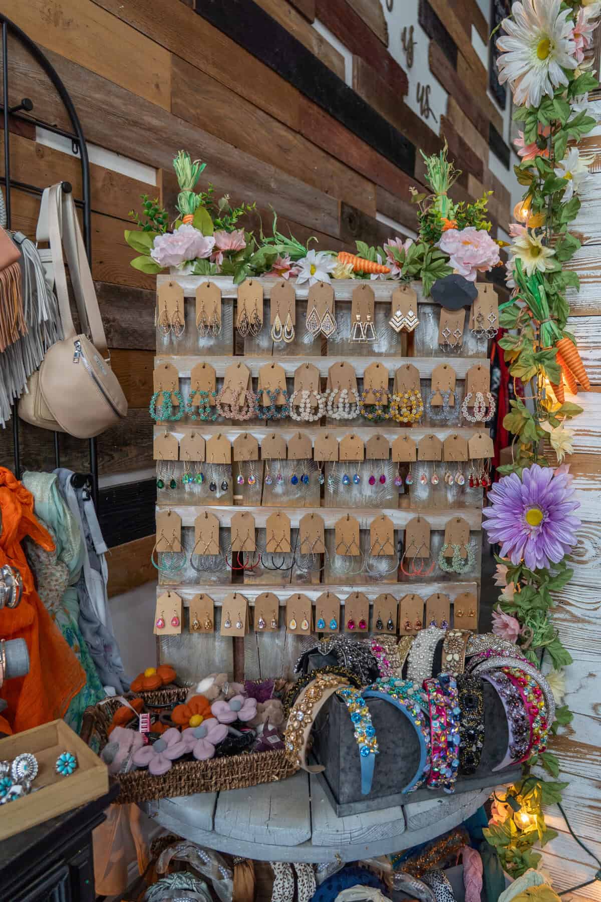 A display of handmade earrings and accessories at Craft Chicks in Tomball