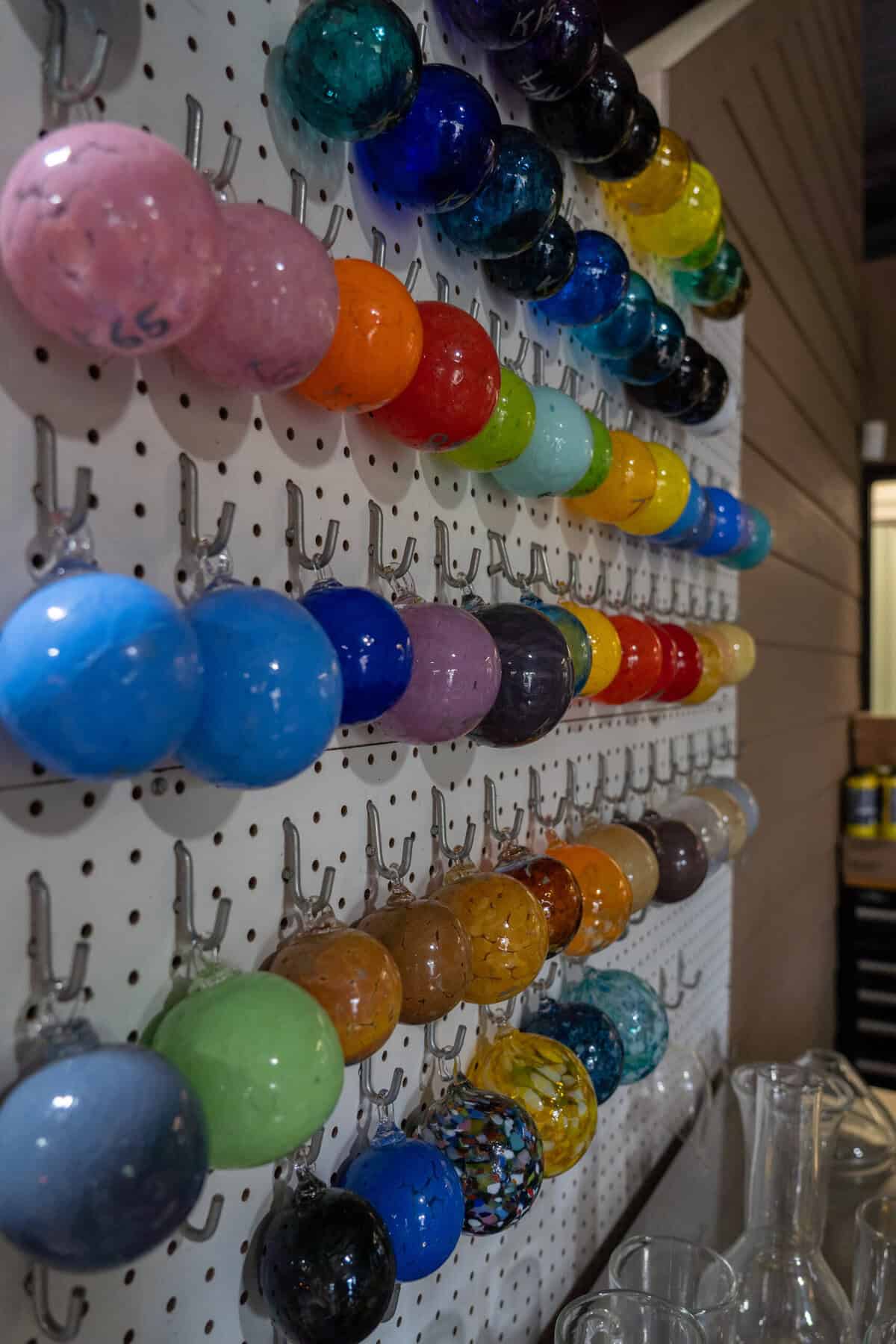 Rows of colorful glass samples inside Houston Glassblowing