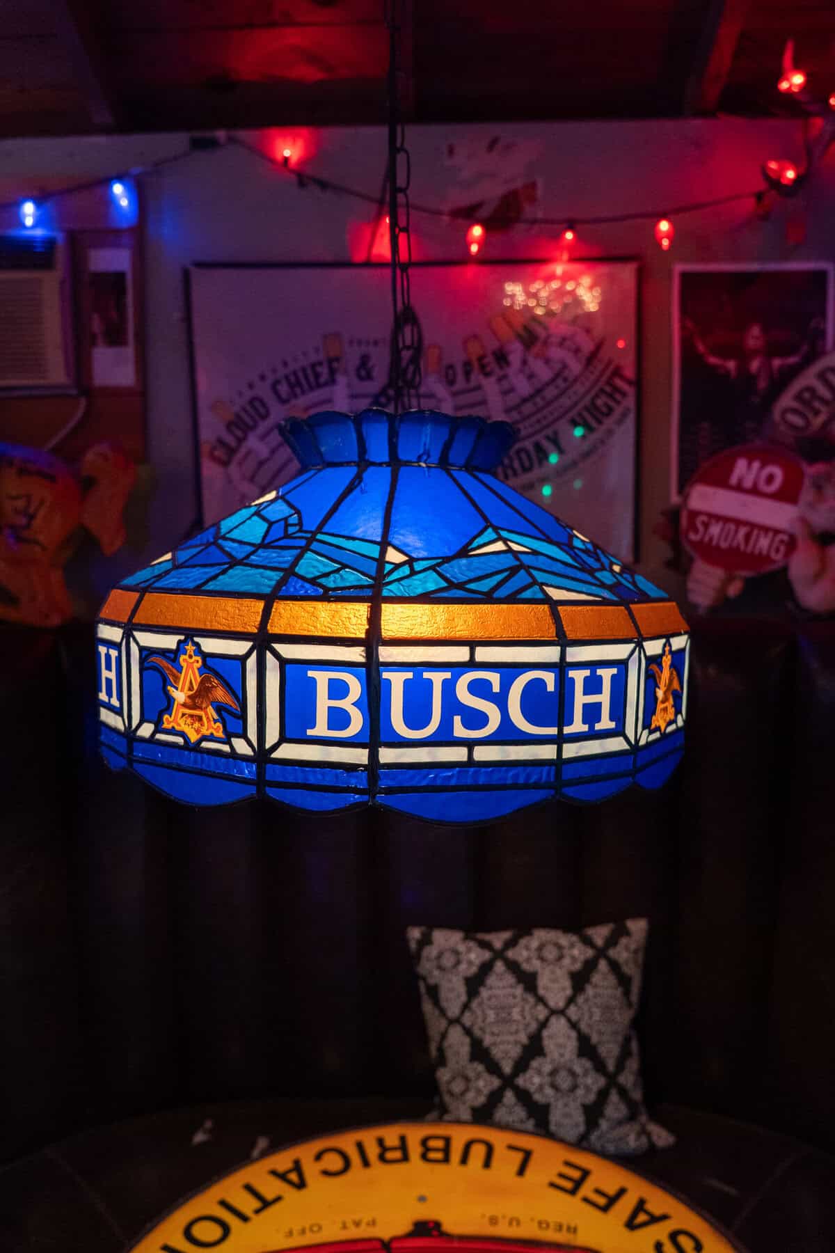 Busch stained glass lamp over a booth inside Old Tomball Honky Tonk