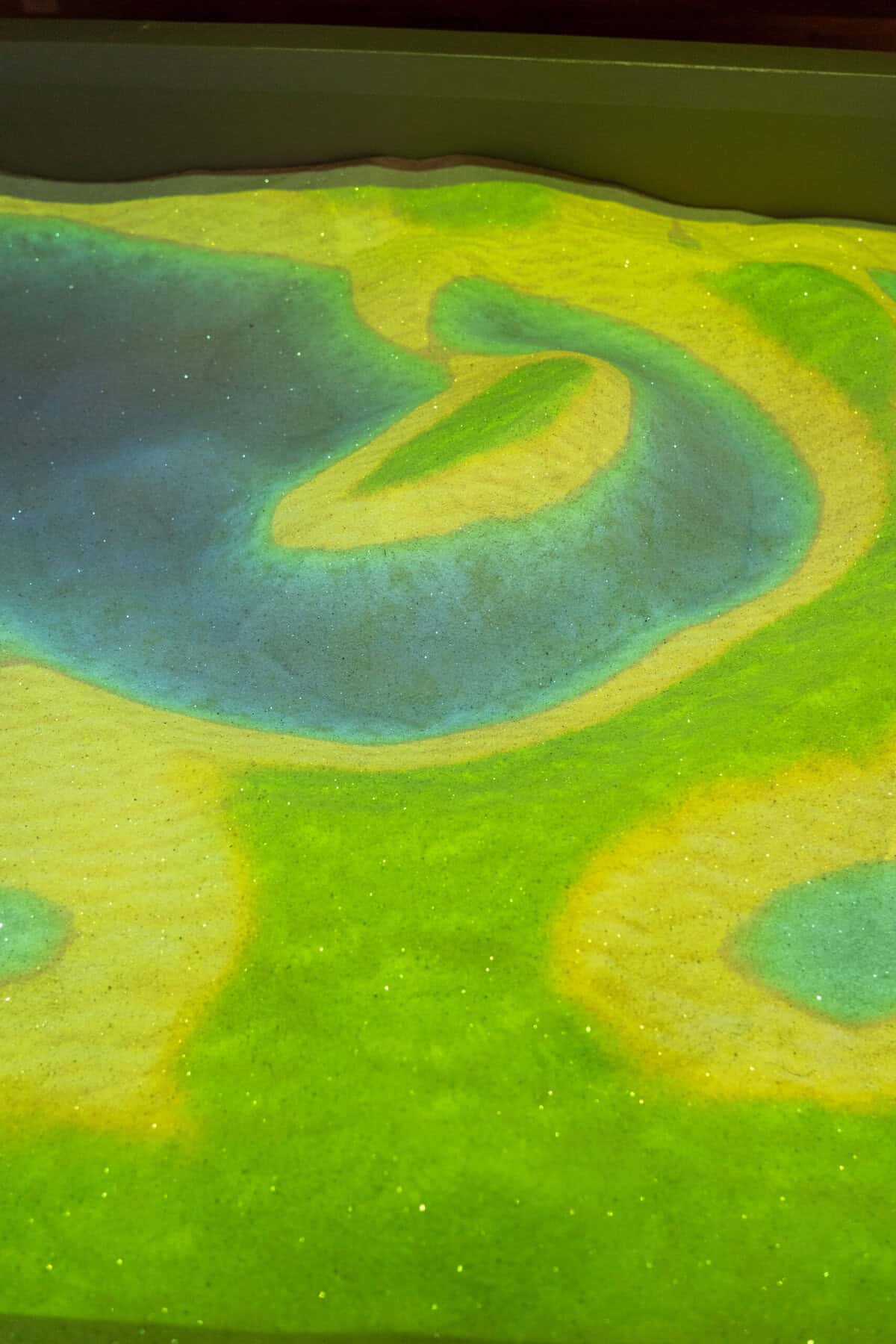 The glowing sand table area inside Once Upon a Cowboy
