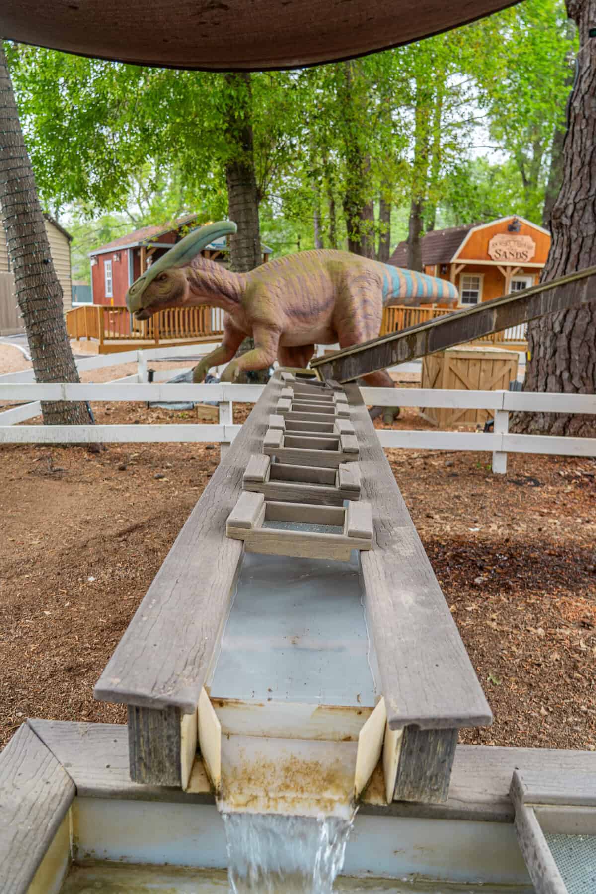 A dinosaur slide in the outdoor play area at Once Upon a Cowboy