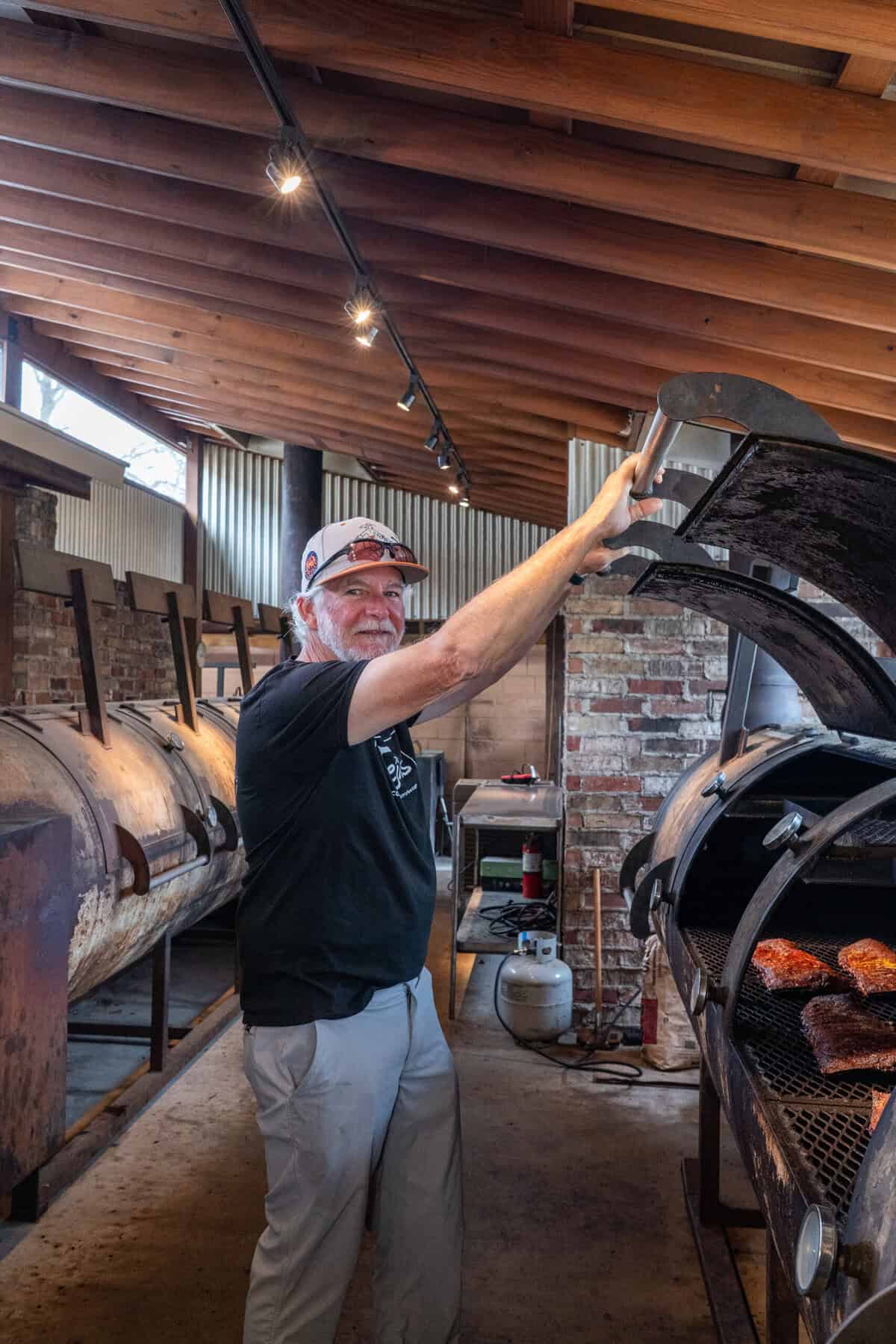 Scott Moore standing by the smokers at Tejas Chocolate and Barbecue