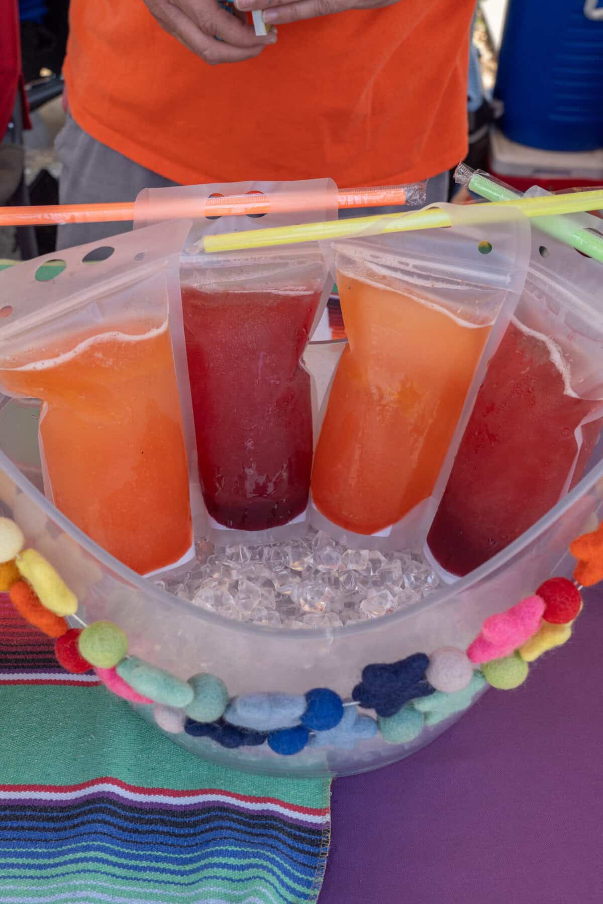 Colorful bagged drinks sit on ice at the Tomball Farmers Market.