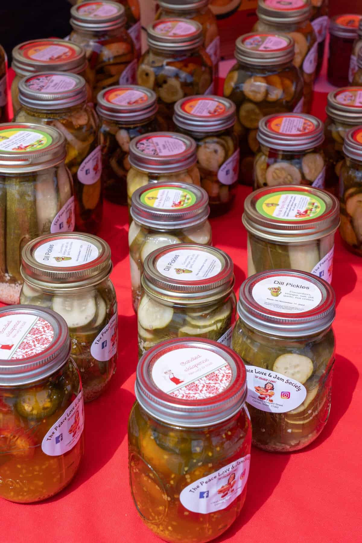 Jarred goods are arranged on a vendor table at the Tomball Farmers Market.