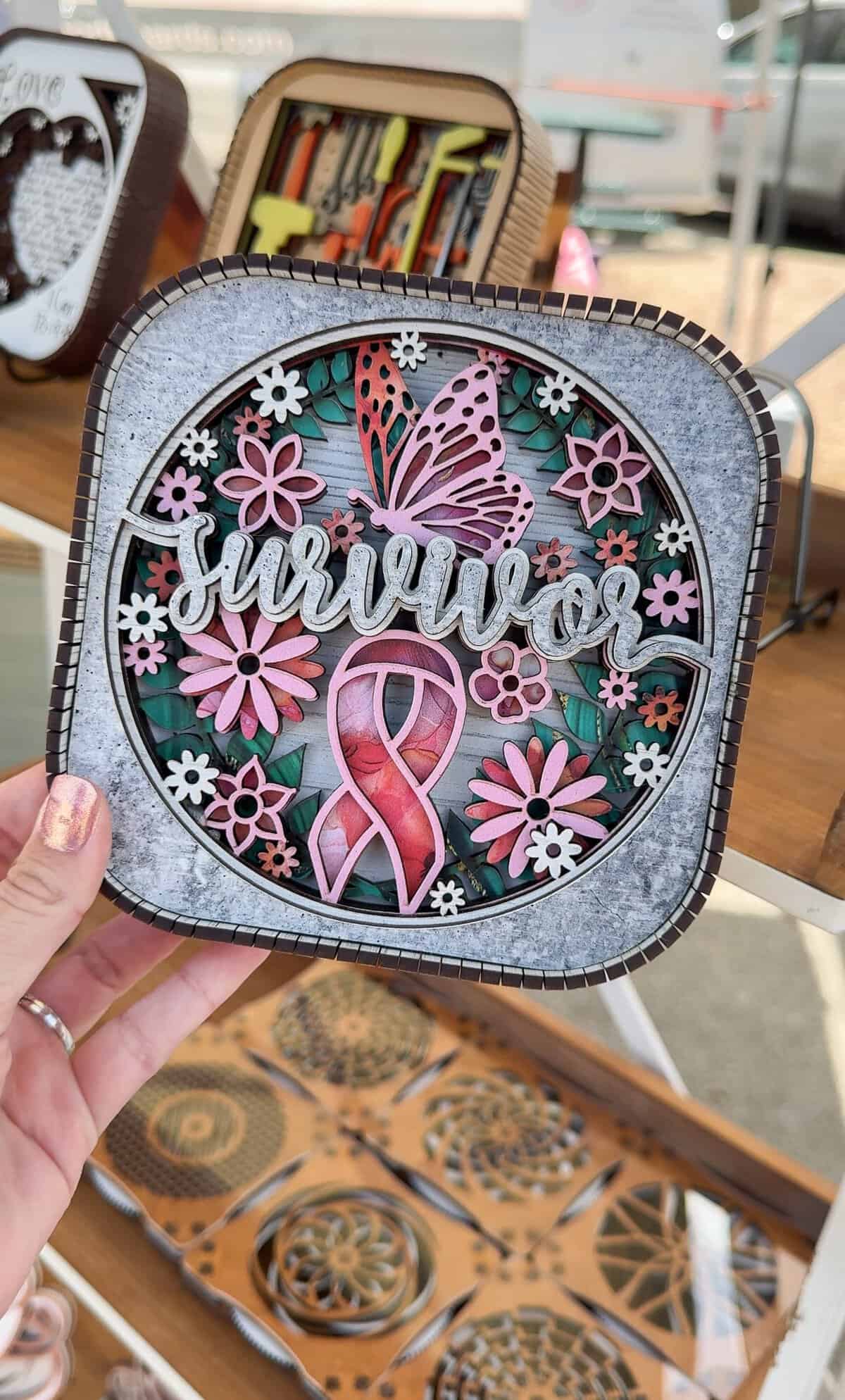 A handcrafted survivor sign is held up at the Tomball Farmers Market.
